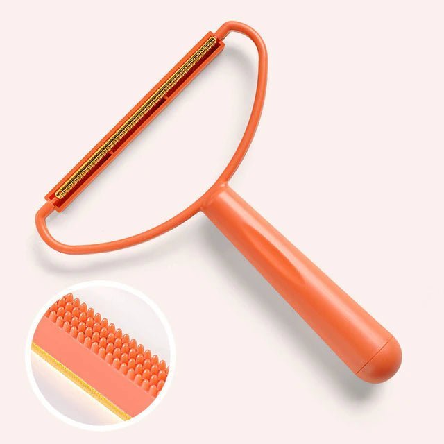 Pet hair cleaning tool in orange on a neutral background