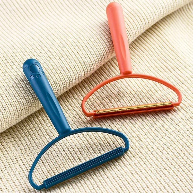 Blue and orange pet hair remover tools on fabric, perfect for removing pet fur and lint from clothes, furniture, and carpets.