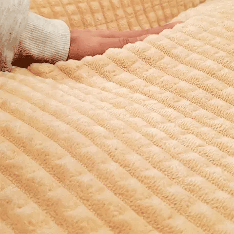 close up of soft pillow cat bed surface as hand glides over the plush fabric