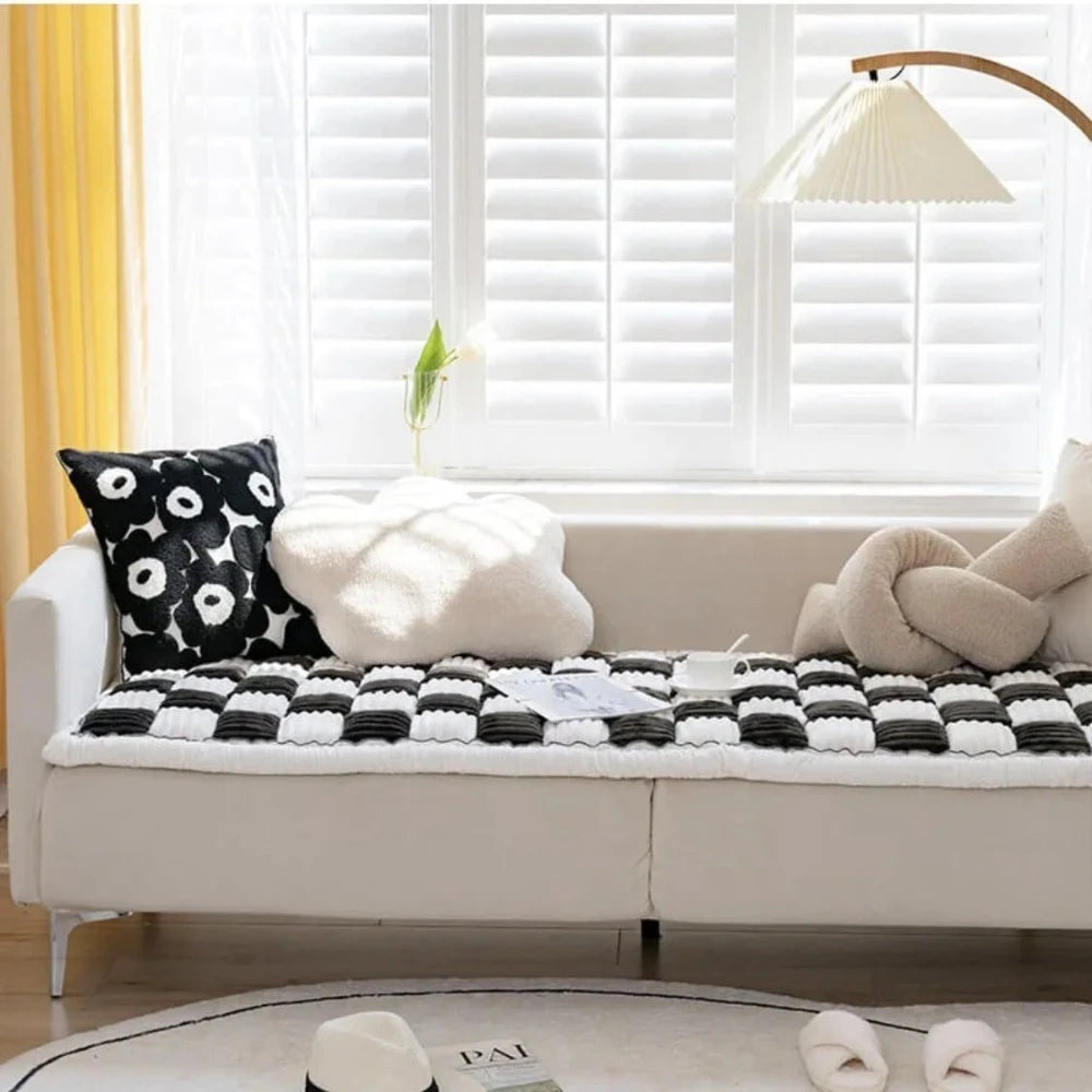 Plush chenille dog and cat sofa cover in black and white checkered pattern, providing stylish furniture protection and comfort.