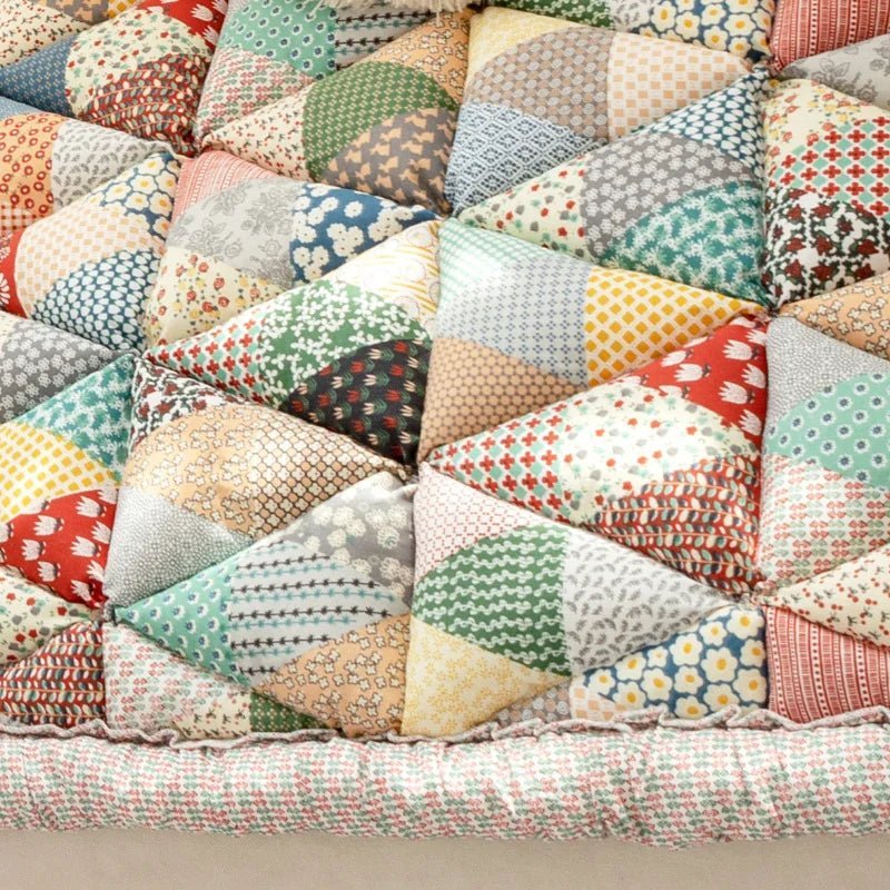 Close-up of colorful rainbow patchwork sofa cover for pets, featuring a vibrant and cozy design for added comfort.