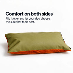 Reversible dog bed cushion with an olive green surface and a soft orange plush underside