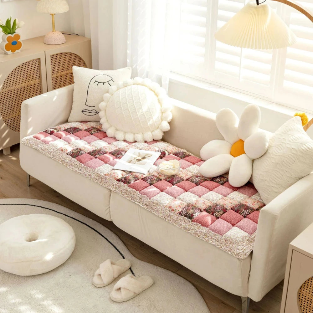 Rose pet sofa cover on couch with pillows, book, and small bowl