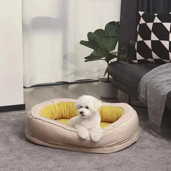 Small white dog resting in a cozy soft oval donut bed with yellow lining, perfect for comfort and support.