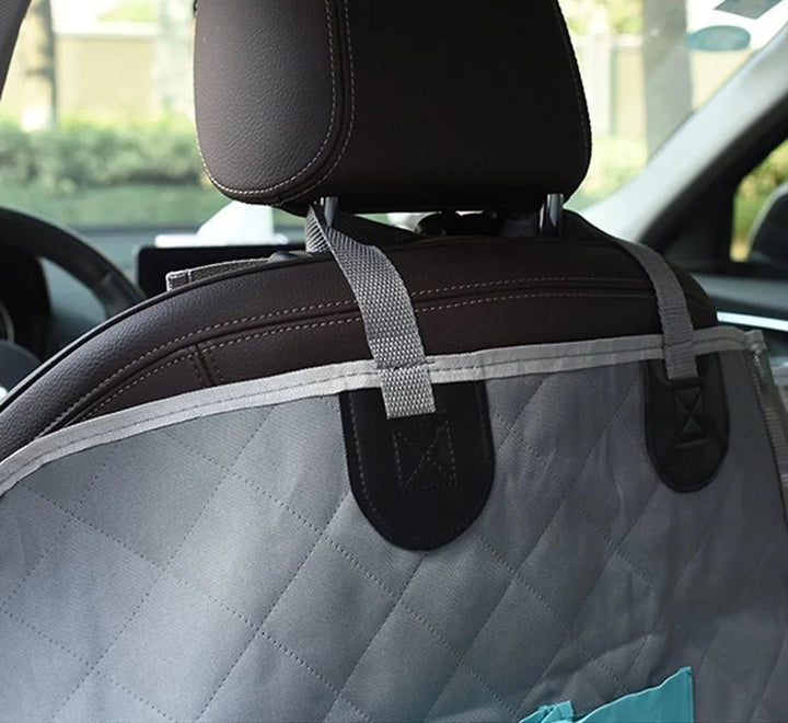 Close view of grey quilted fabric strapped to front seat headrest