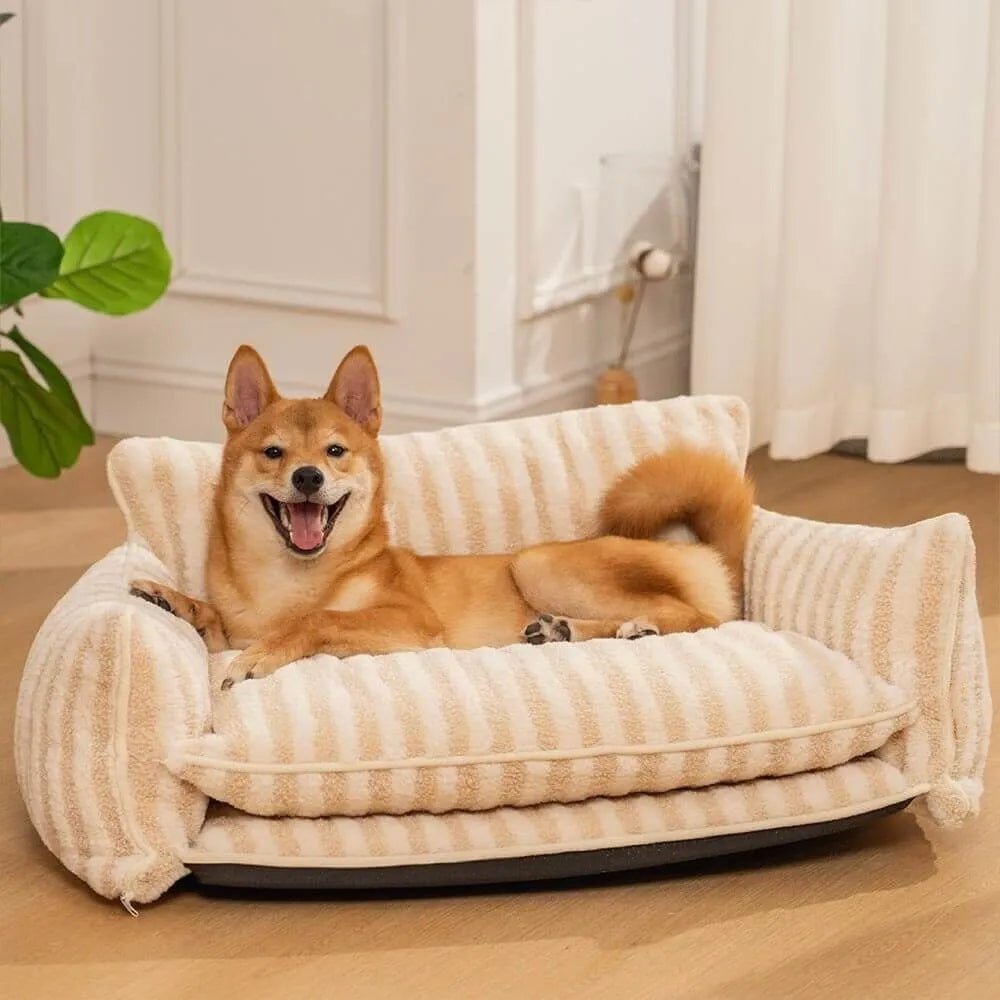 Dog relaxing on a beige striped plush sofa bed for pets, made with soft faux lamb wool for ultimate comfort.