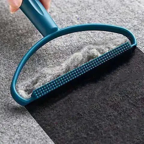 Pet hair tool for carpet removing fur from a gray rug