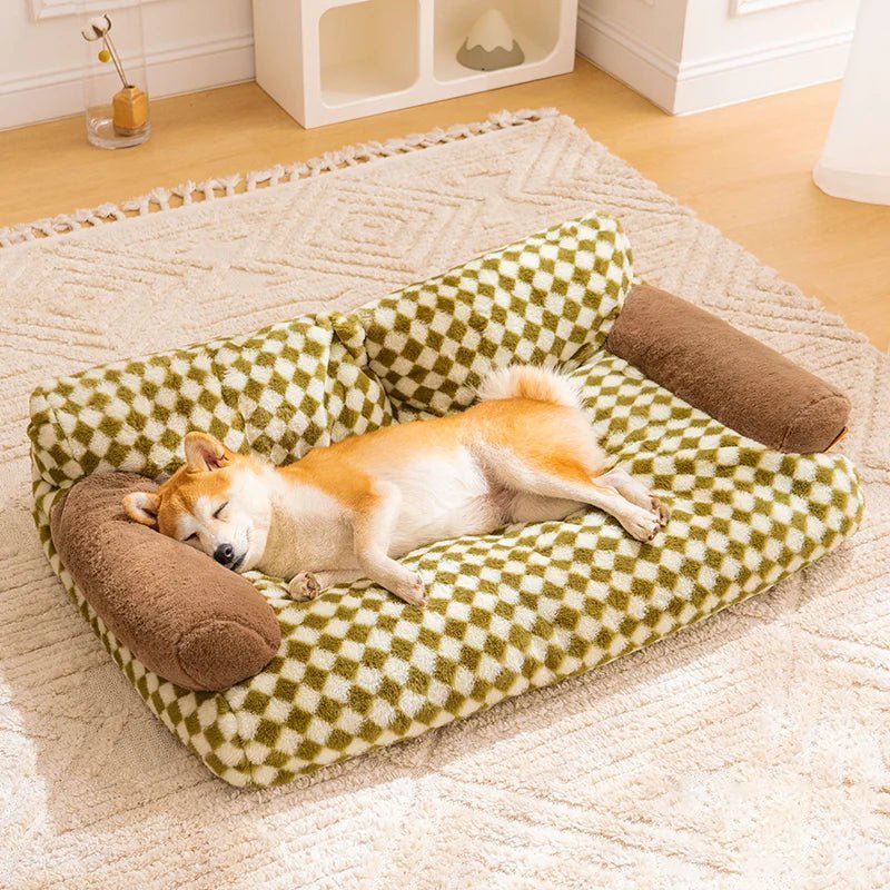 Dog sleeping comfortably on a green vintage-patterned plush pet sofa bed, ideal for cozy naps and home decor elegance.