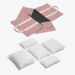 Pink car seat cover unfolded with white pillows for pets