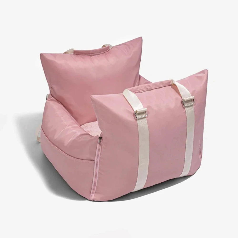 Waterproof pink dog car seat with padded straps and secure design, ideal for safe and comfortable pet travel.