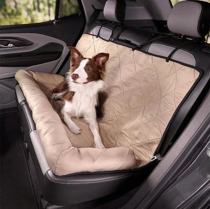 Dog sitting comfortably on a beige waterproof car seat cover with pillow, perfect for protecting seats during travel.