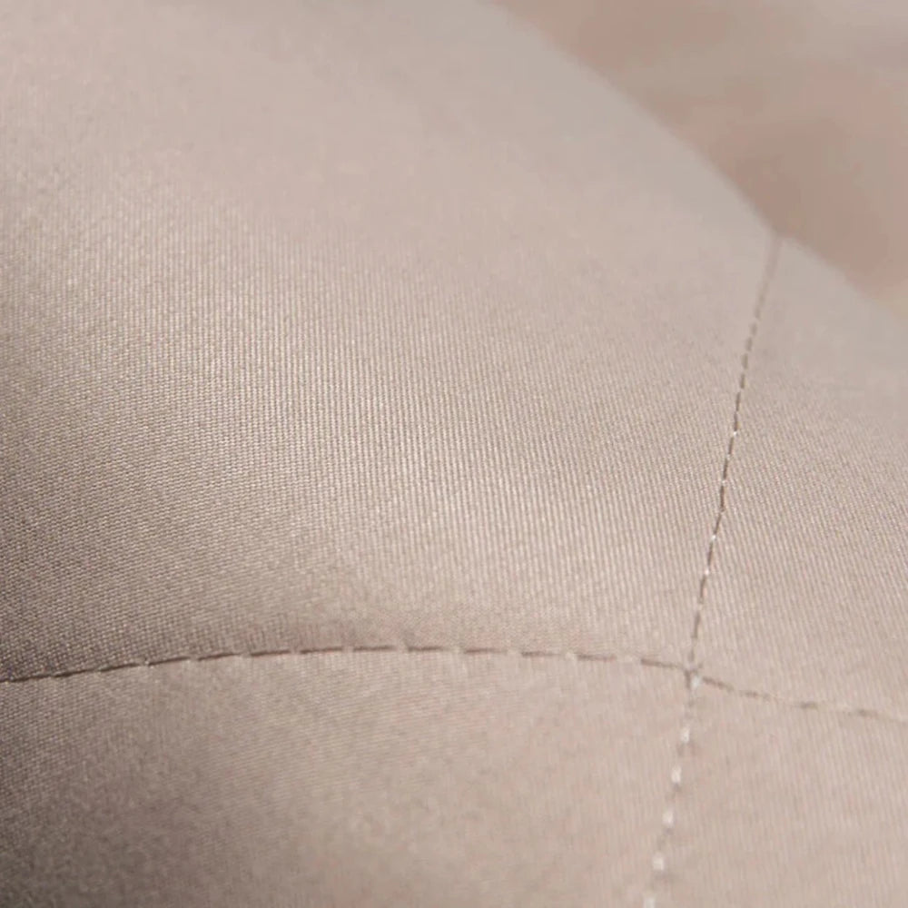 Close-up of quilted fabric on a waterproof dog car seat cover, offering durability and comfort for pet travel protection.