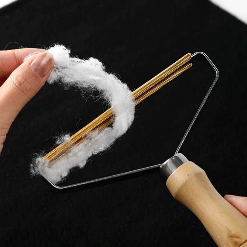 Wooden pet fur remover tool in action, easily removing pet hair from fabric with a sturdy metal frame for efficient cleaning.