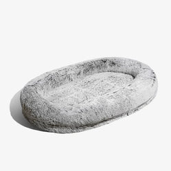Giant dog bed for human in grey on a white background