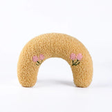 Yellow soft calming pet pillow in a U-shape with floral embroidery